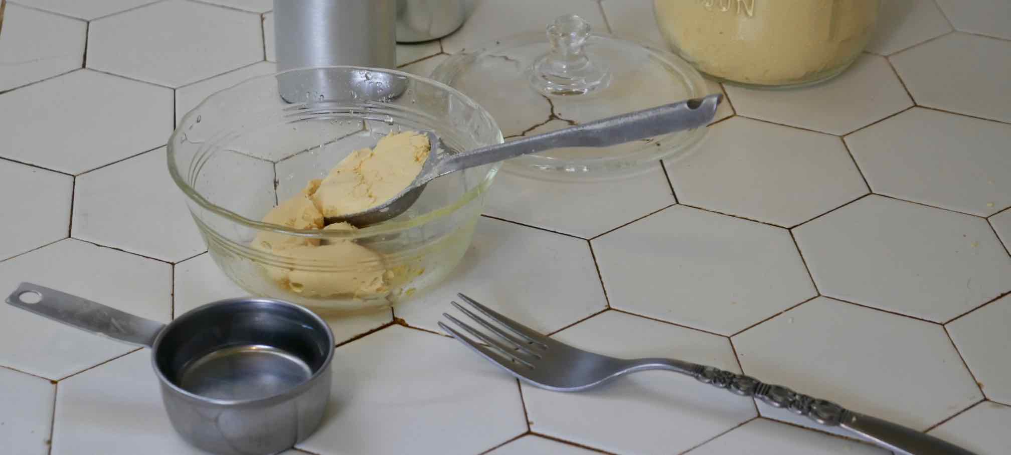 dried egg powder being measured into baking dish