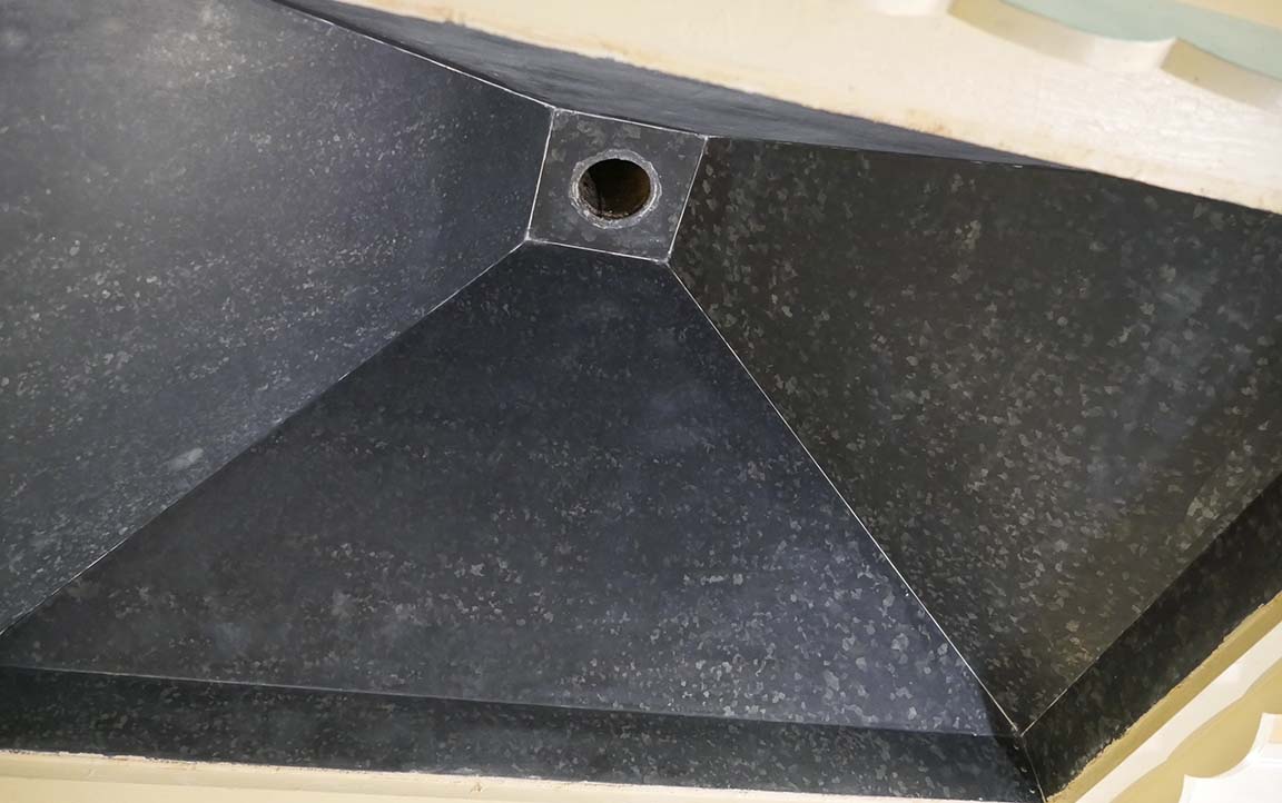 restored stove hood with black metal looking as it did when installed over the wood-burning stove in 1929.